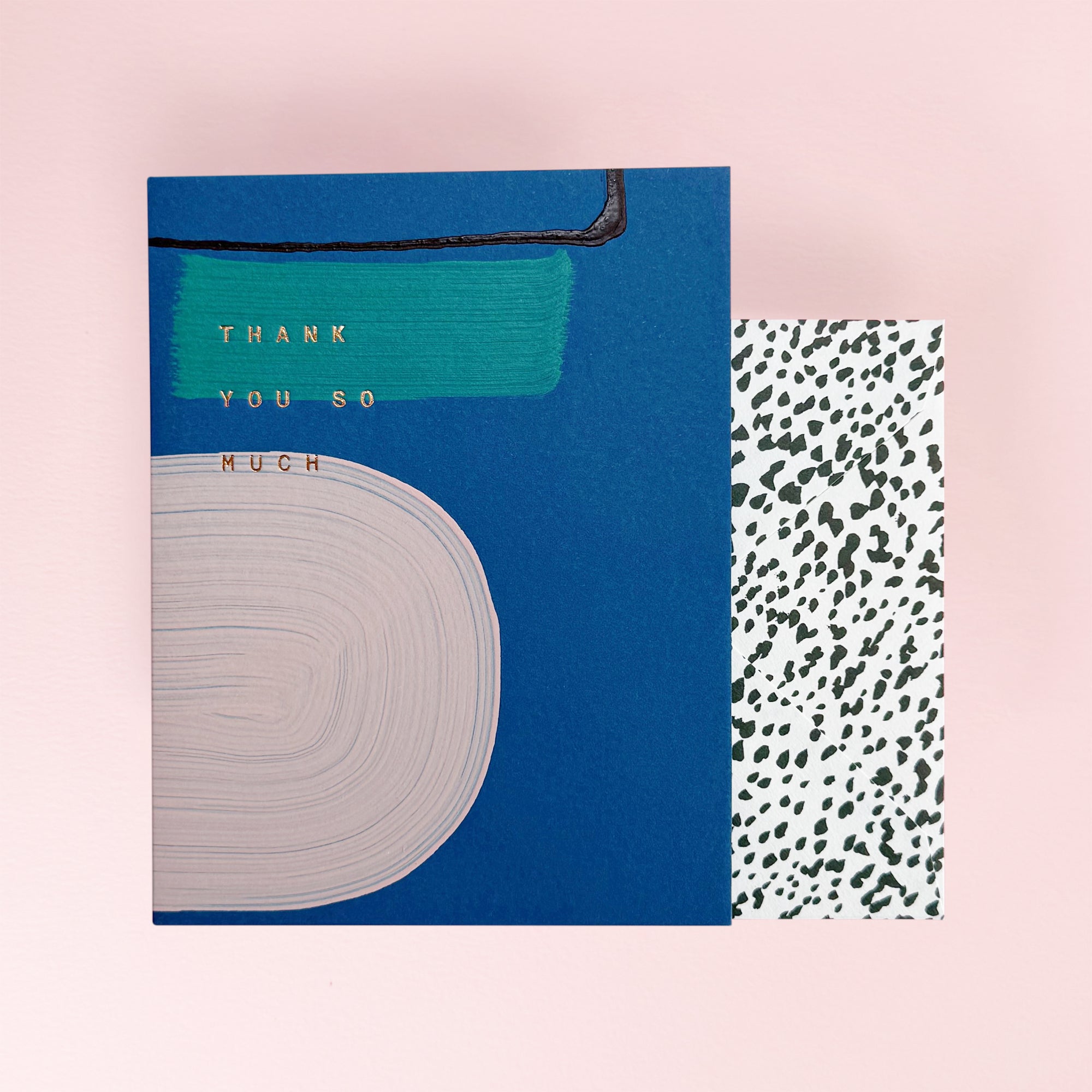 Blue greeting card with abstract design and thank you so much emvossed in gold. Plus an envelope