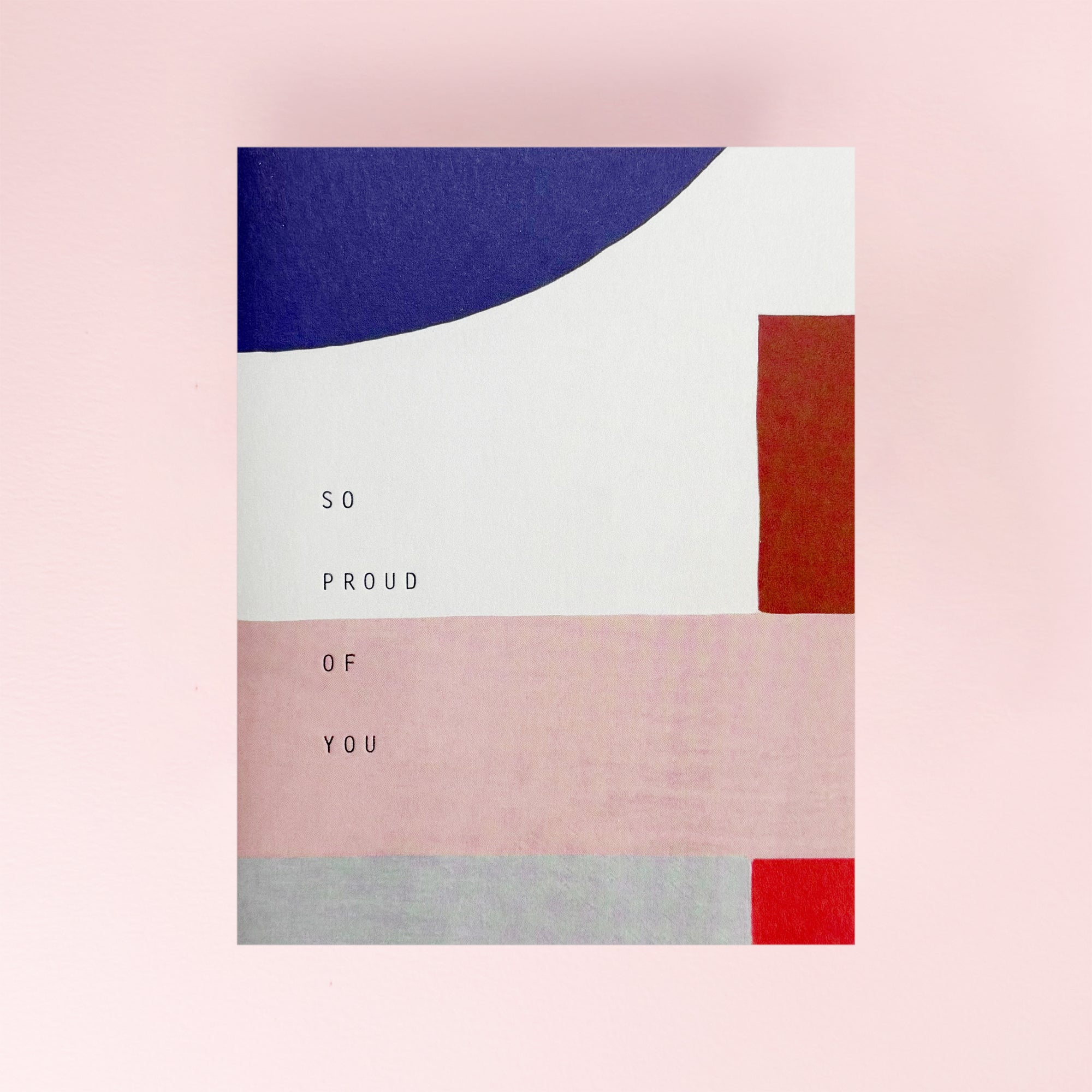 Card with geometric design and 'So Proud of You' text on a pink background
