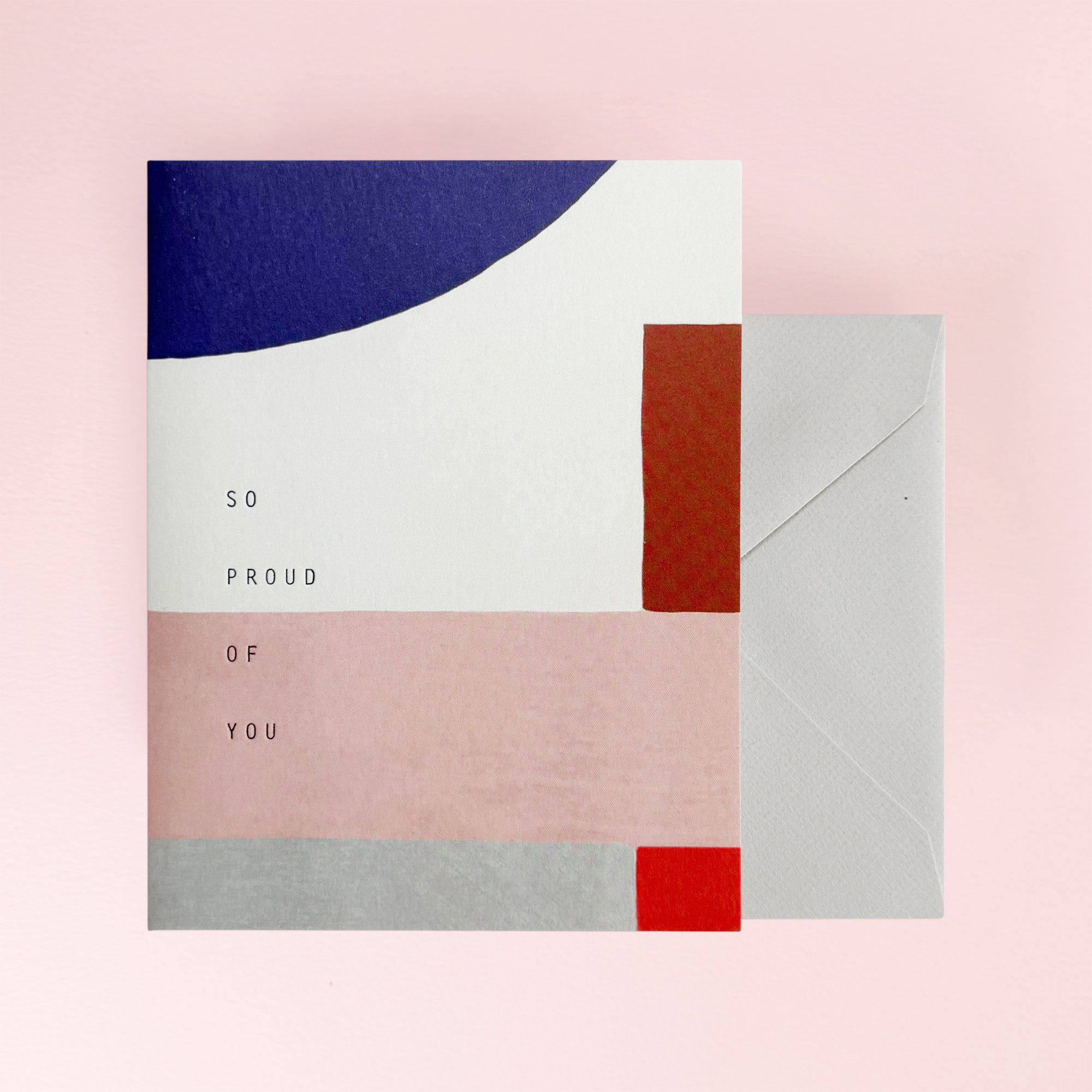 Greeting card with 'So proud of you' text and a grey envelope