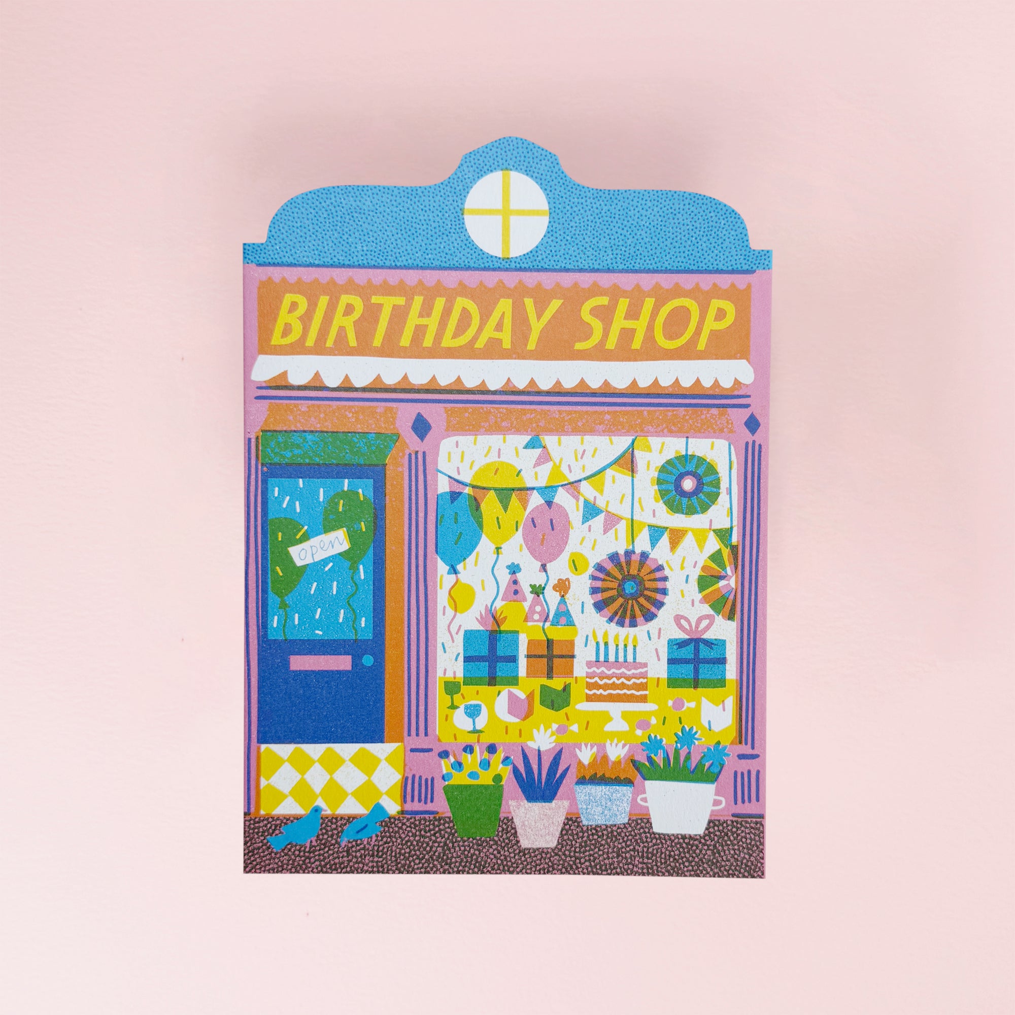 Illustration of a 'Birthday Shop' with colorful decorations on a pink background