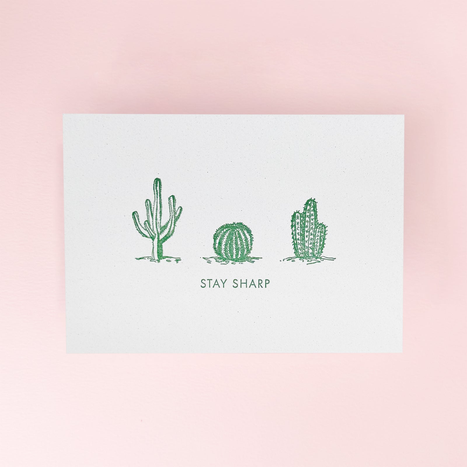 Three cactus illustrations on a white card with 'Stay Sharp' text on a greeting card